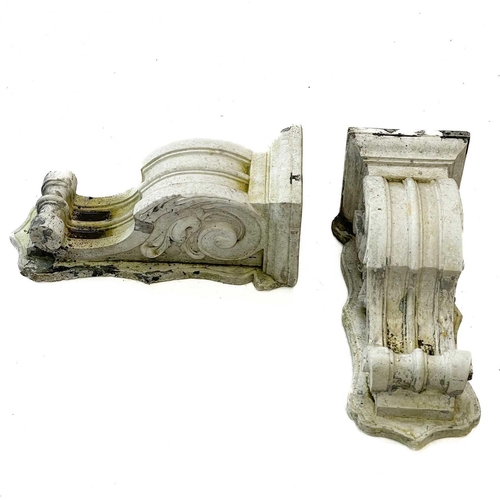 75 - A pair of reconstituted stone corbels. Height 36cm, width 14cm, depth 14.5cm.