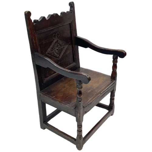 77 - A 17th century oak North Country Wainscot armchair. With a shaped top rail carved central lozenge, h... 