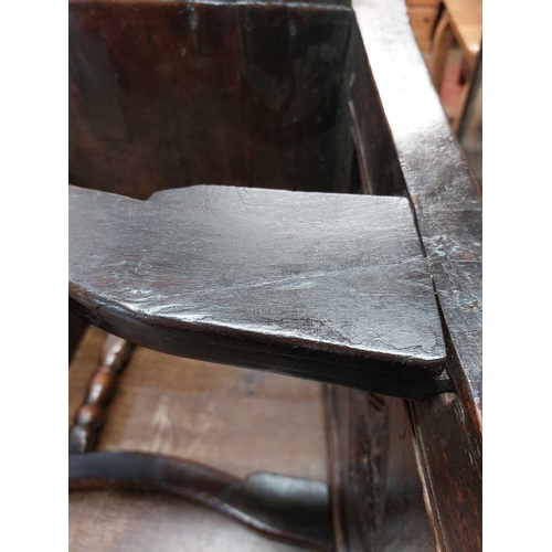 77 - A 17th century oak North Country Wainscot armchair. With a shaped top rail carved central lozenge, h... 