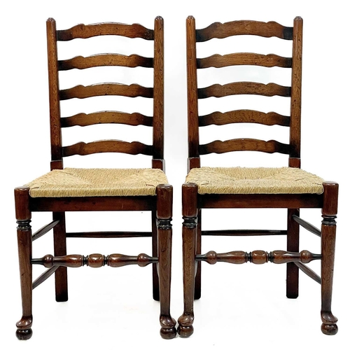 87 - Six 20th century ash and oak ladder back chairs. With drop in rush seats and two carvers. (6)Stirdy,... 