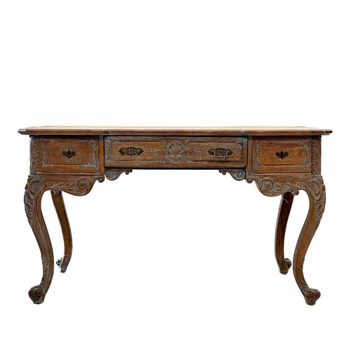 88 - A Continental oak bureau plat. 19th century, fitted three frieze drawers with rococo scroll carved d... 