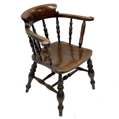 97 - A Victorian oak bow smokers chair. Height 81cm width 67cm depth 56cm.