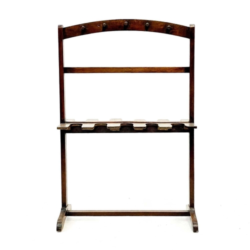 98 - A mahogany whip and boot rack. Early 20th century, with ten pegs and fitted for five pairs of boots,... 