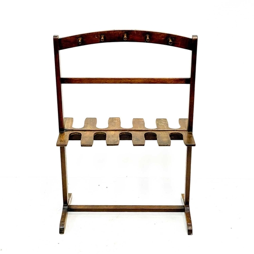 98 - A mahogany whip and boot rack. Early 20th century, with ten pegs and fitted for five pairs of boots,... 