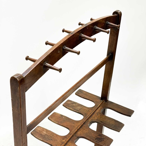 98 - A mahogany whip and boot rack. Early 20th century, with ten pegs and fitted for five pairs of boots,... 