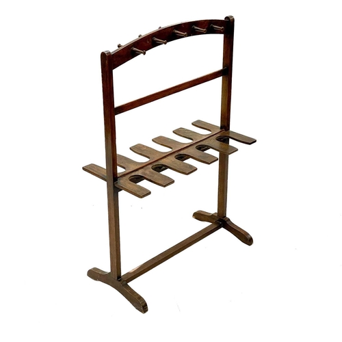 98 - A mahogany whip and boot rack. Early 20th century, with ten pegs and fitted for five pairs of boots,... 