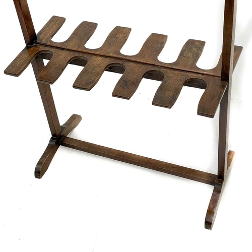 98 - A mahogany whip and boot rack. Early 20th century, with ten pegs and fitted for five pairs of boots,... 