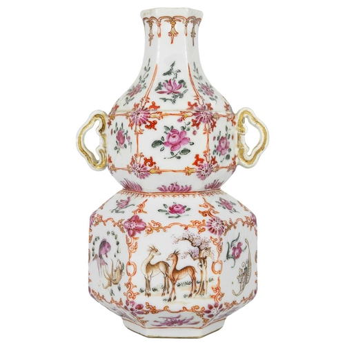 131 - A Chinese famille rose porcelain double gourd vase, circa 1760. With twin handles and decorated with... 
