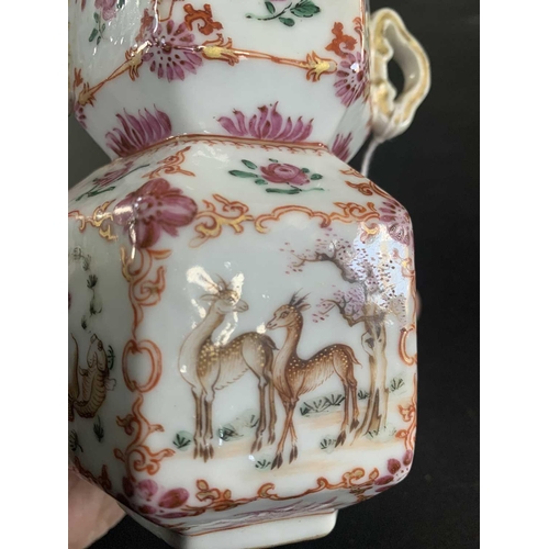 131 - A Chinese famille rose porcelain double gourd vase, circa 1760. With twin handles and decorated with... 