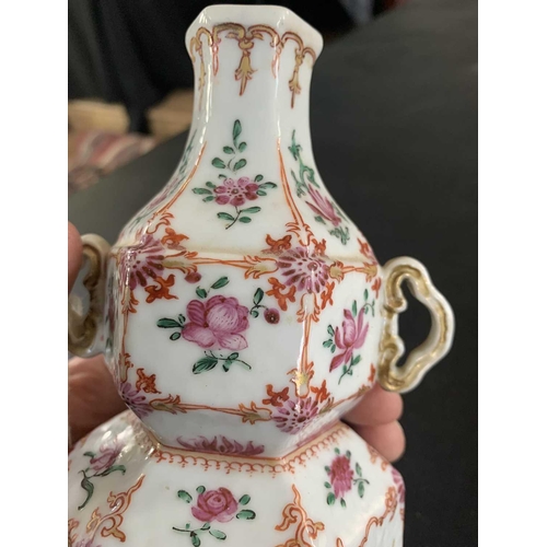 131 - A Chinese famille rose porcelain double gourd vase, circa 1760. With twin handles and decorated with... 