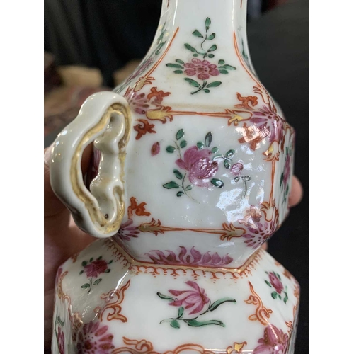 131 - A Chinese famille rose porcelain double gourd vase, circa 1760. With twin handles and decorated with... 