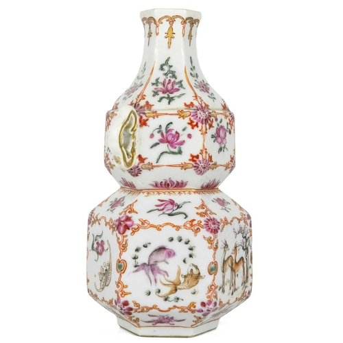 131 - A Chinese famille rose porcelain double gourd vase, circa 1760. With twin handles and decorated with... 