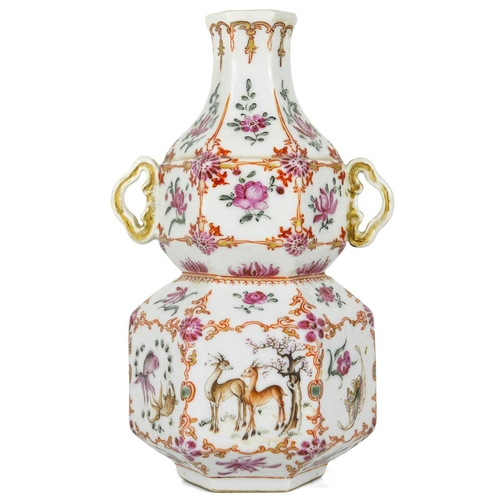 131 - A Chinese famille rose porcelain double gourd vase, circa 1760. With twin handles and decorated with... 