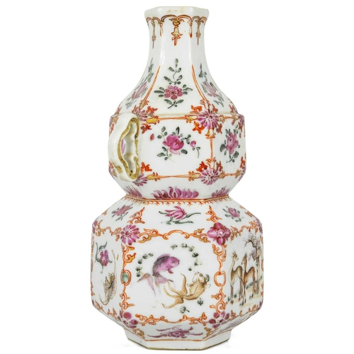 131 - A Chinese famille rose porcelain double gourd vase, circa 1760. With twin handles and decorated with... 