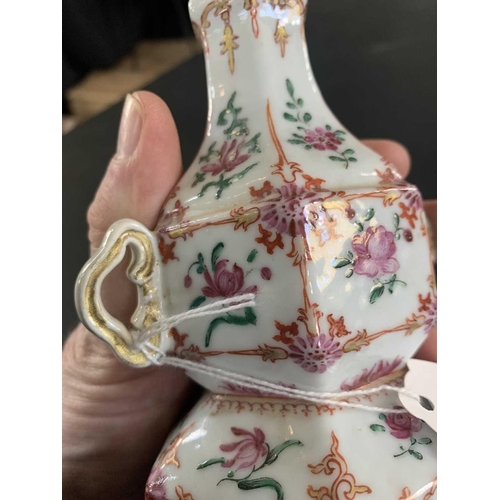 131 - A Chinese famille rose porcelain double gourd vase, circa 1760. With twin handles and decorated with... 