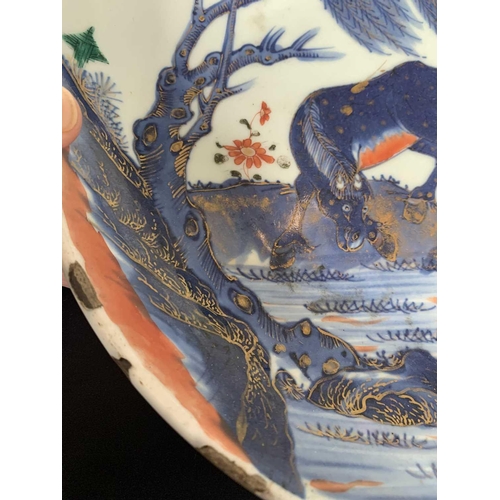 141 - A Chinese Imari porcelain dish, 18th century. With horses in a landscape and standing beneath a will... 