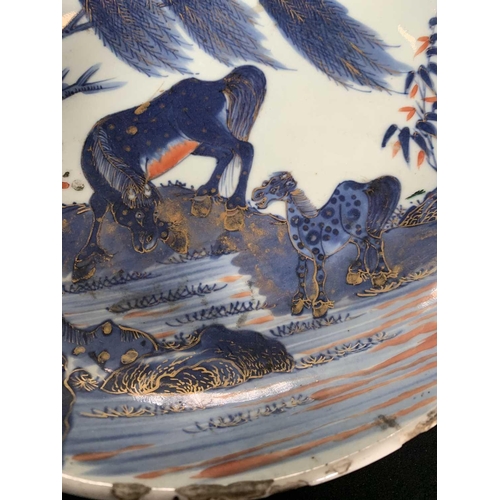 141 - A Chinese Imari porcelain dish, 18th century. With horses in a landscape and standing beneath a will... 