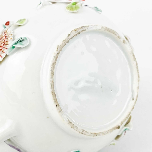 144 - A Chinese porcelain teapot, mid 18th century. .With applied floral and leaf decoration, height 12cm,... 