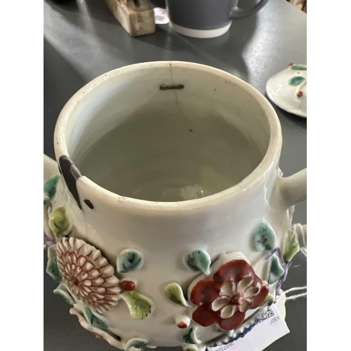 144 - A Chinese porcelain teapot, mid 18th century. .With applied floral and leaf decoration, height 12cm,... 