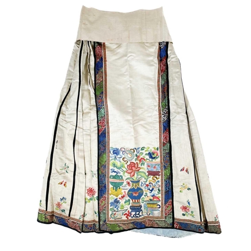 168 - An attractive Chinese silk embroidered pleated skirt, 19th century. The cream ground with multiple f... 