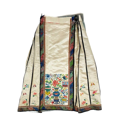 168 - An attractive Chinese silk embroidered pleated skirt, 19th century. The cream ground with multiple f... 