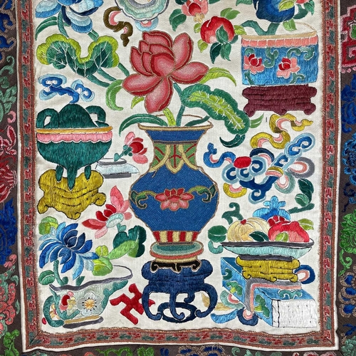 168 - An attractive Chinese silk embroidered pleated skirt, 19th century. The cream ground with multiple f... 