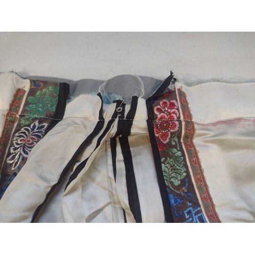 168 - An attractive Chinese silk embroidered pleated skirt, 19th century. The cream ground with multiple f... 