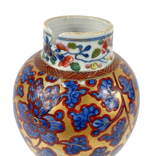 58 - A Chinese 'clobbered' porcelain vase and cover, 19th century. The gilt ground with scrolling foliage... 