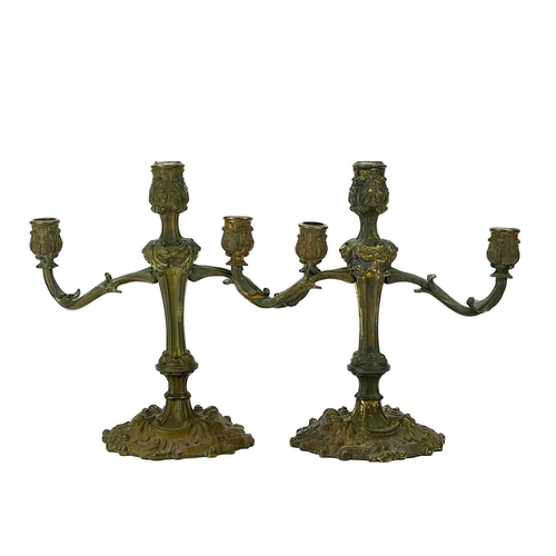 101 - A pair of rococo style ormolu candelabra. Possibly English, circa 1820, each with twin branches, the... 