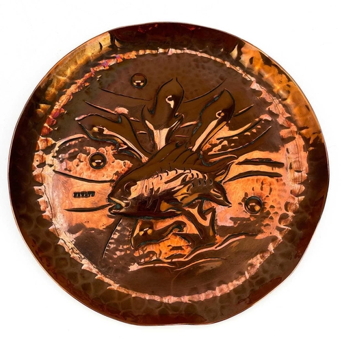 102 - A suite of three Newlyn copper dishes. Each repousse decorated with fish and seaweed on a planished ... 