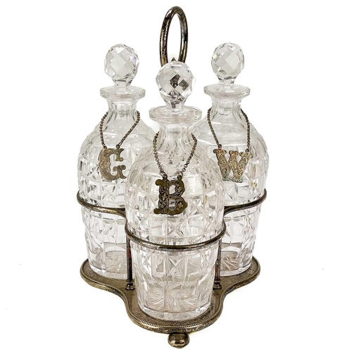 107 - A late Victorian three bottle silver plated decanter stand. With ring handle and fitted with three p... 