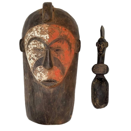 110 - A Fang, Gabon tribal mask. With painted decoration, height 40cm, together with a carved African spoo... 