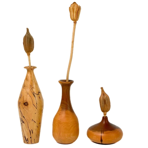 112 - A selection of wood turned and carved items. Including vases, and bowls, the tallest vase 14.5cm.