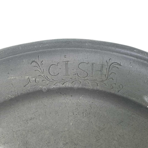 140 - A pewter plate marked 1759 inscribed with the owner's initials. Diameter - 22.5cm together with two ... 