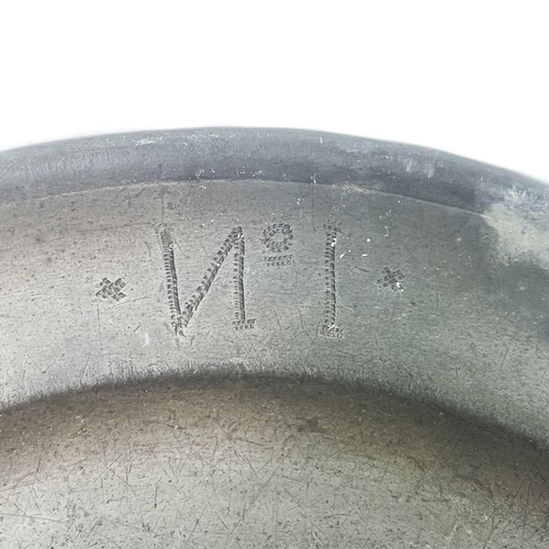 140 - A pewter plate marked 1759 inscribed with the owner's initials. Diameter - 22.5cm together with two ... 