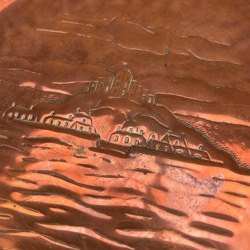 141 - A Newlyn copper small dish or pin tray. Repousse decorated with a view of St Michael's Mount, diamet... 