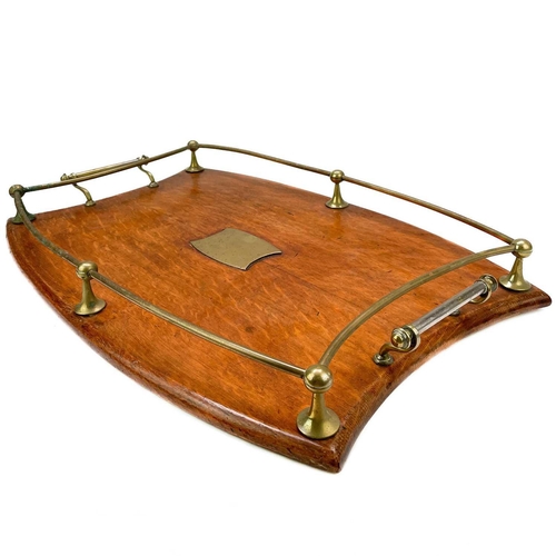 142 - An Edwardian oak and brass butler's tray. With waisted ends and tubular gallery, with twin handles, ... 