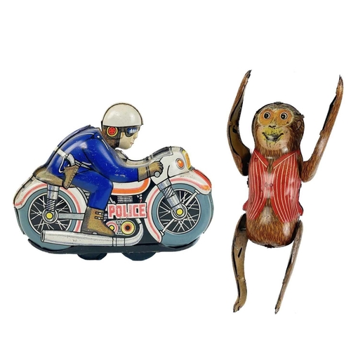 145 - A tin clockwork tumbling monkey circa 1960s. Height 8cm, together with a tin clockwork Police motorc... 