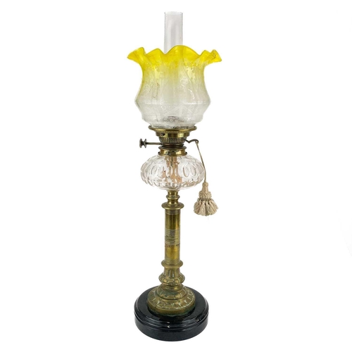 158 - A Victorian brass oil lamp with a glass reservoir and etched yellow shade. On a circular base, clear... 