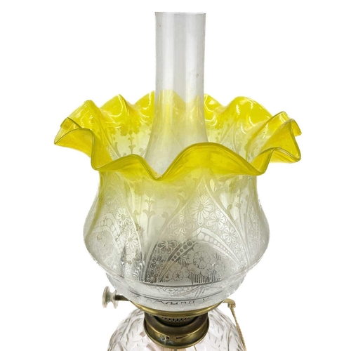 158 - A Victorian brass oil lamp with a glass reservoir and etched yellow shade. On a circular base, clear... 