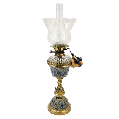 176 - A Victorian brass oil lamp with a ceramic and glass oil reservoir and clear glass shade. With painte... 