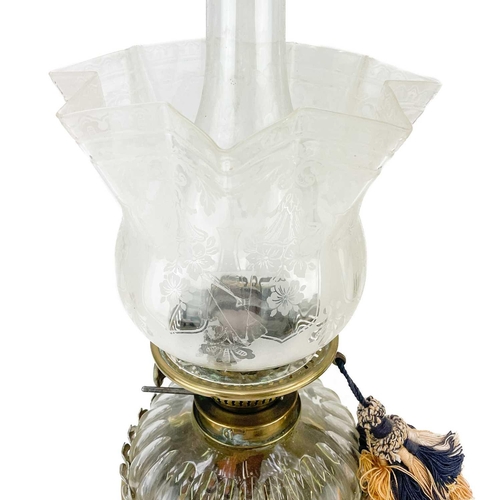 176 - A Victorian brass oil lamp with a ceramic and glass oil reservoir and clear glass shade. With painte... 