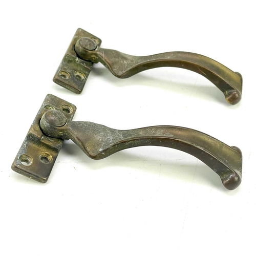 198 - A pair of Victorian brass rails. Width 32cm, and four window casement stays.