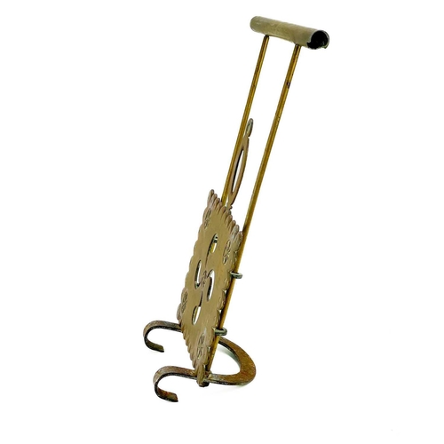 204 - A Victorian brass sliding trivet. With heavy foliate pierced stand, length 49cm.