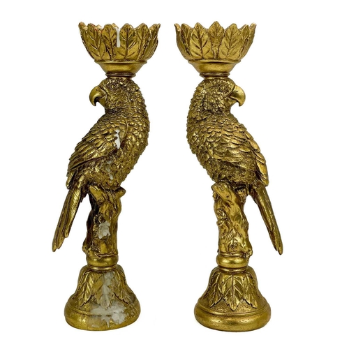 215 - A pair of gold painted candle stick holders modelled as parrots. Height 33.5cm.