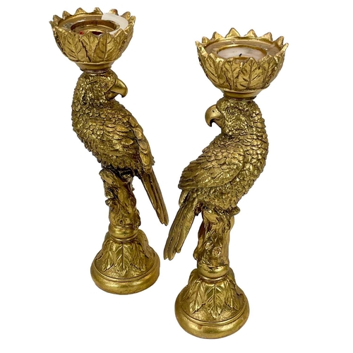 215 - A pair of gold painted candle stick holders modelled as parrots. Height 33.5cm.