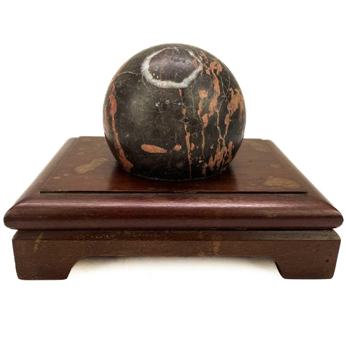 22 - A Torquay Devon turned marble sphere. Late Victorian, diameter 11cm, on a mahogany stand. There is a... 