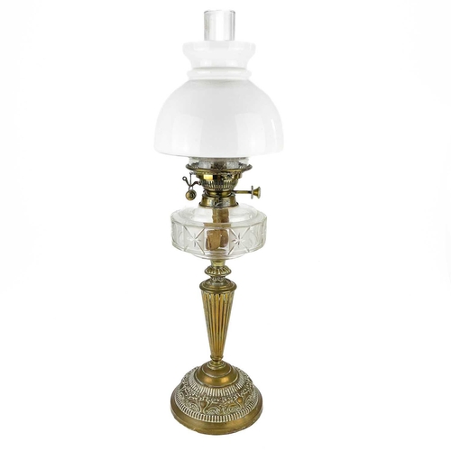 220 - A Victorian brass oil lamp with a glass reservoir and a white glass shade. with a domed white glass ... 