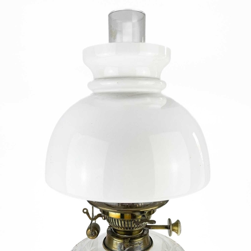 220 - A Victorian brass oil lamp with a glass reservoir and a white glass shade. with a domed white glass ... 