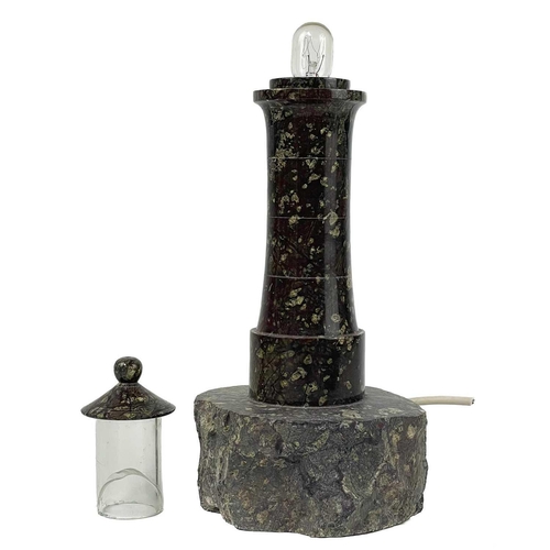 227 - A cornish turned serpentine lighthouse table lamp. On a naturalistic base, height 30.5cm. This lamp ... 